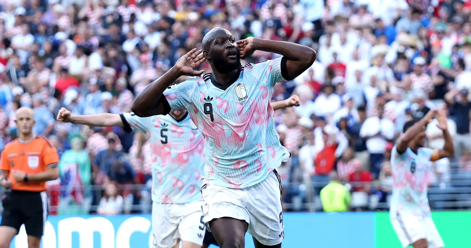 Player celebrating a goal with teammates in match Player celebrating a goal with teammates in match
