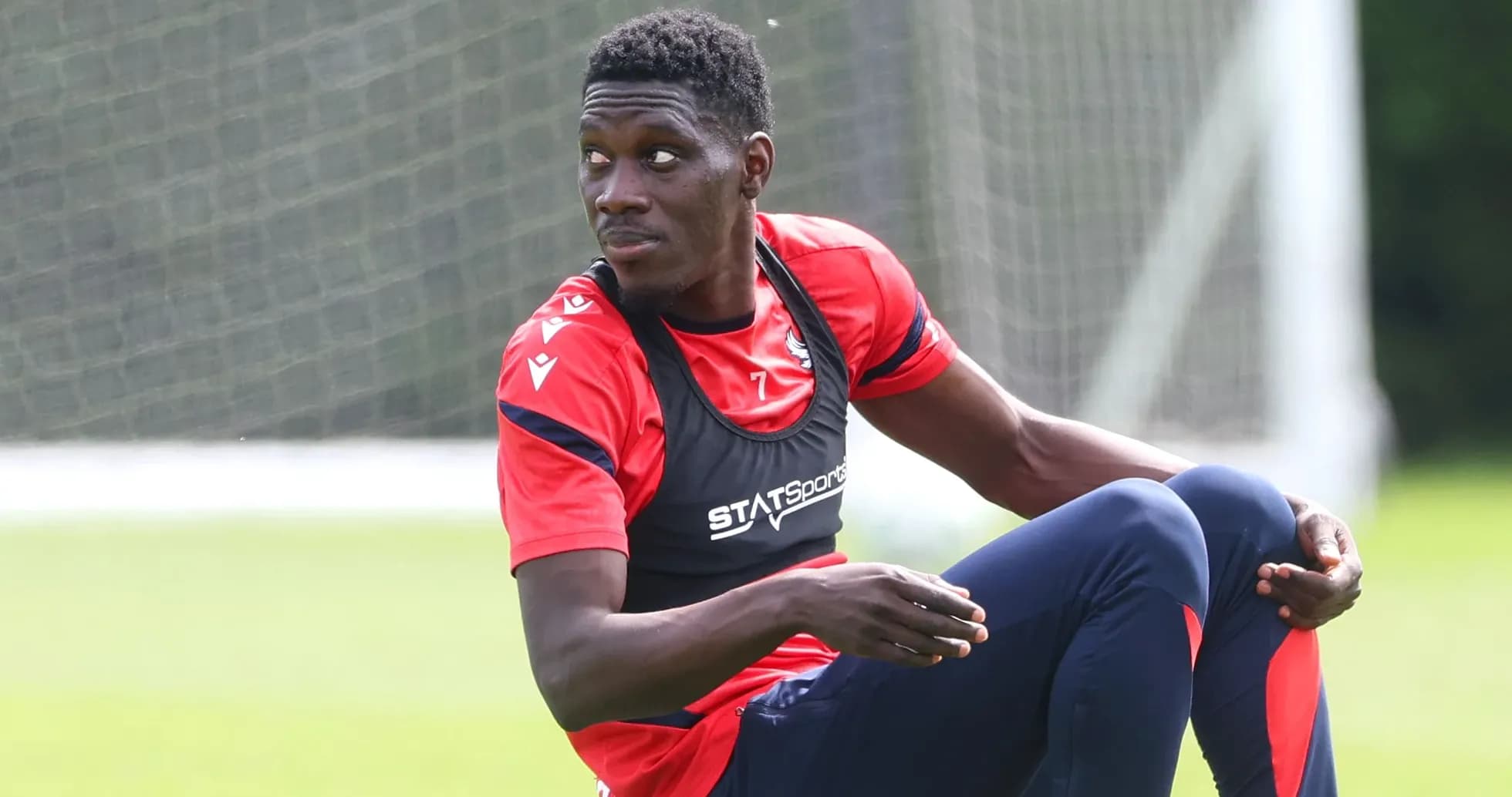 Player sitting on training ground during session Player sitting on training ground during session