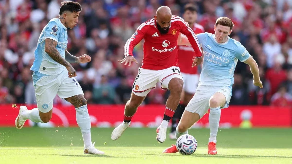 Manchester United and Manchester City players competing for the ball Manchester United and Manchester City players competing for the ball