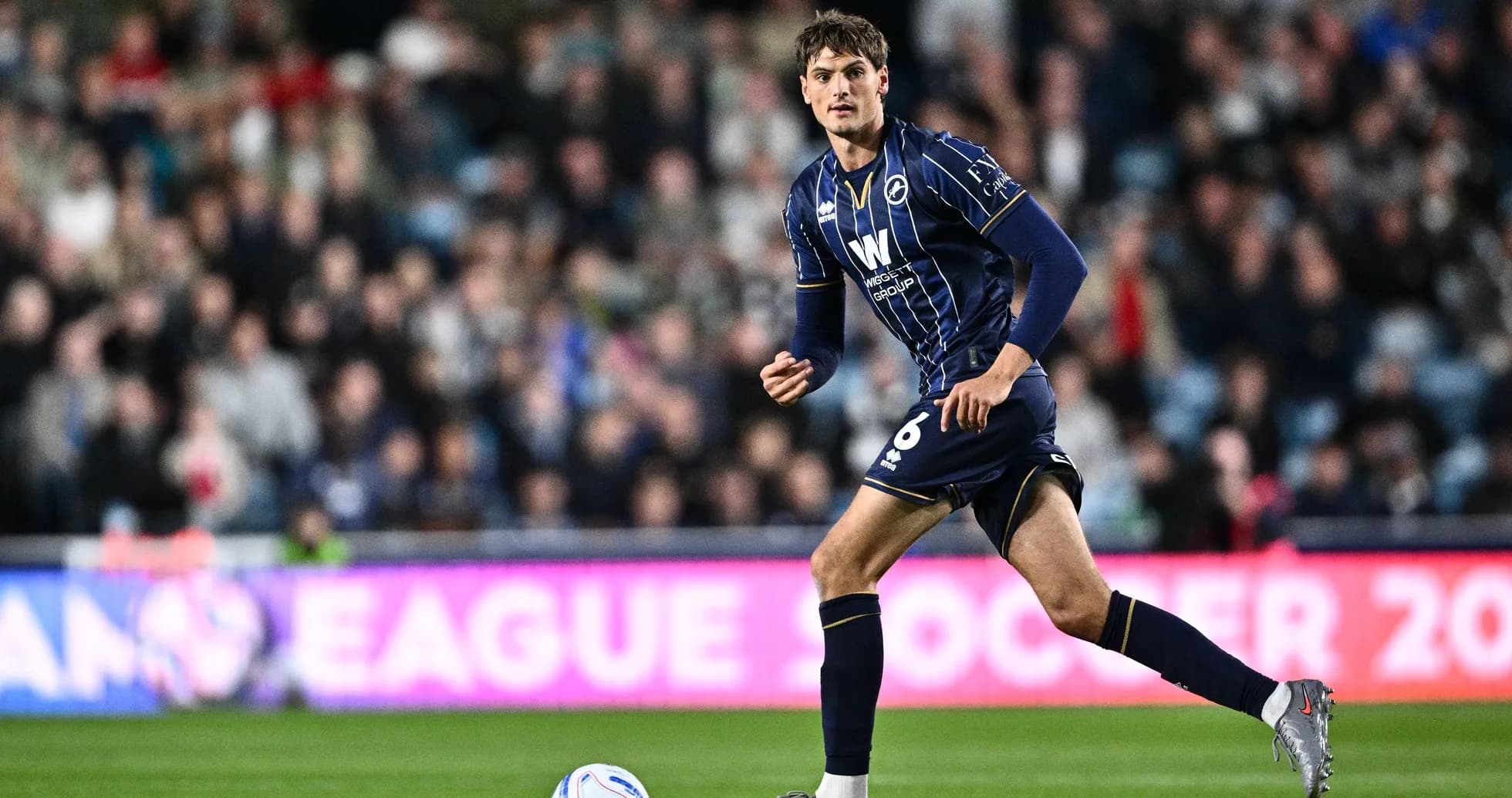 Player dribbling the ball during a match Player dribbling the ball during a match