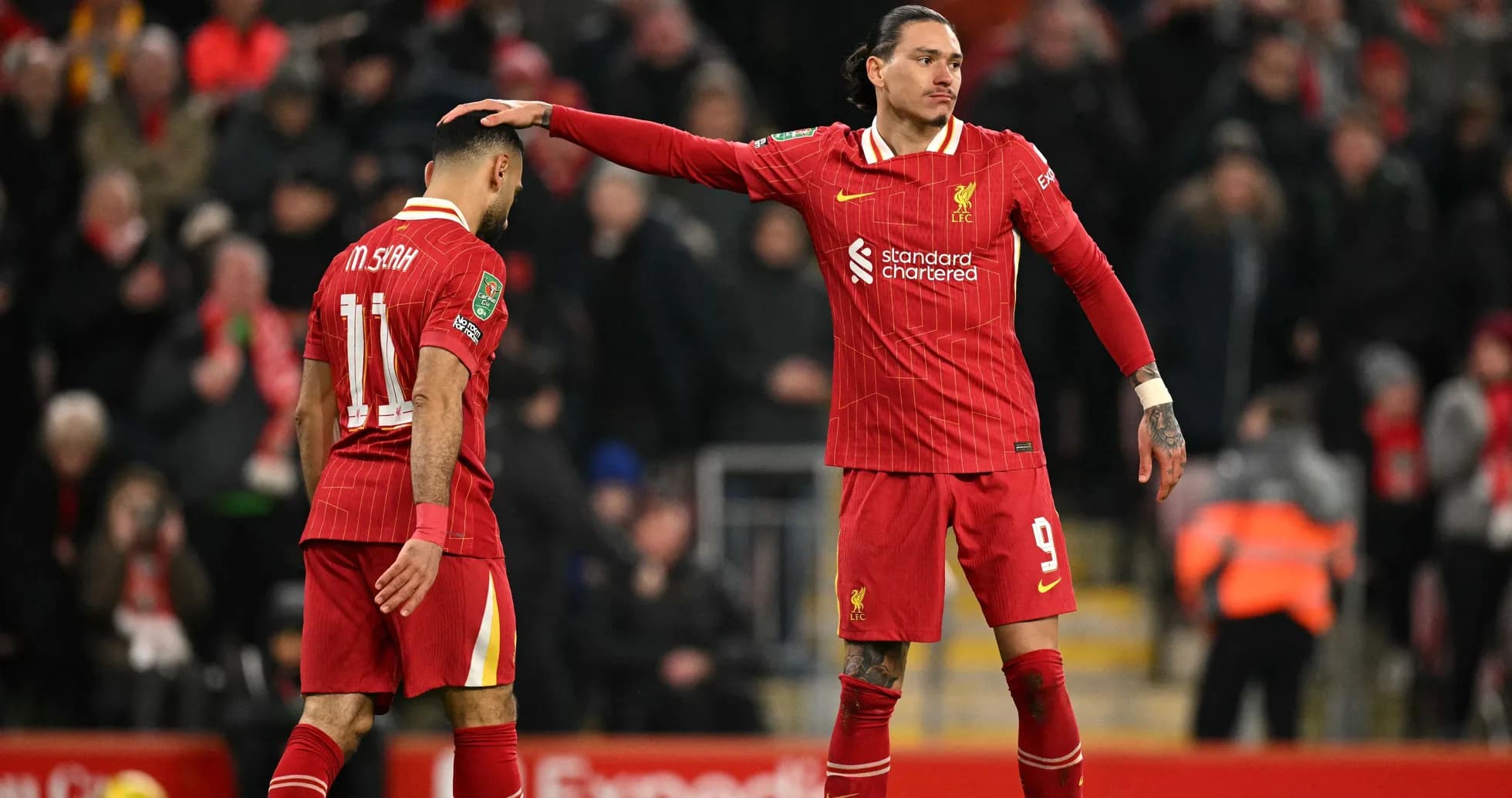 Two Liverpool players on the pitch after a match Two Liverpool players on the pitch after a match