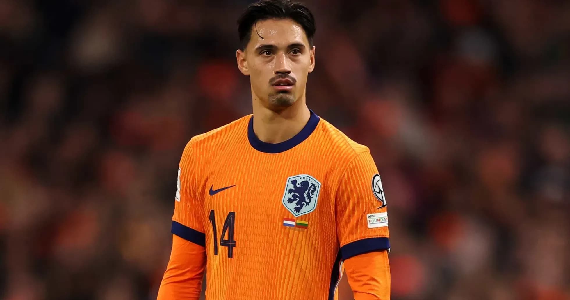 Player in orange Netherlands jersey on the field Player in orange Netherlands jersey on the field