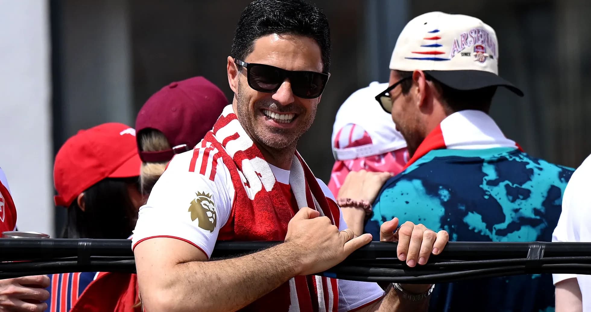 Man in sunglasses smiling at a celebration event Man in sunglasses smiling at a celebration event