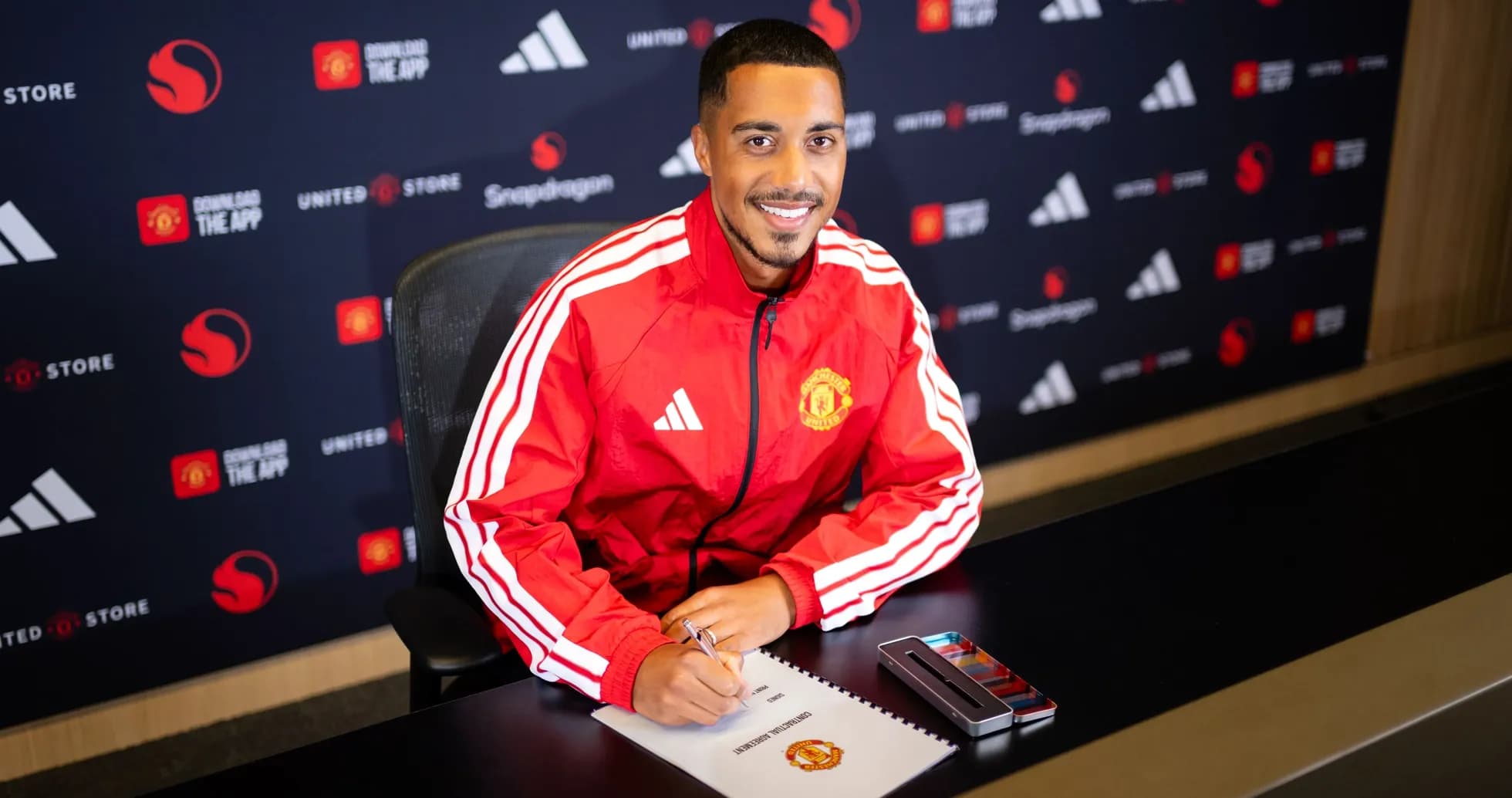 Player signing contract at Manchester United signing event Player signing contract at Manchester United signing event