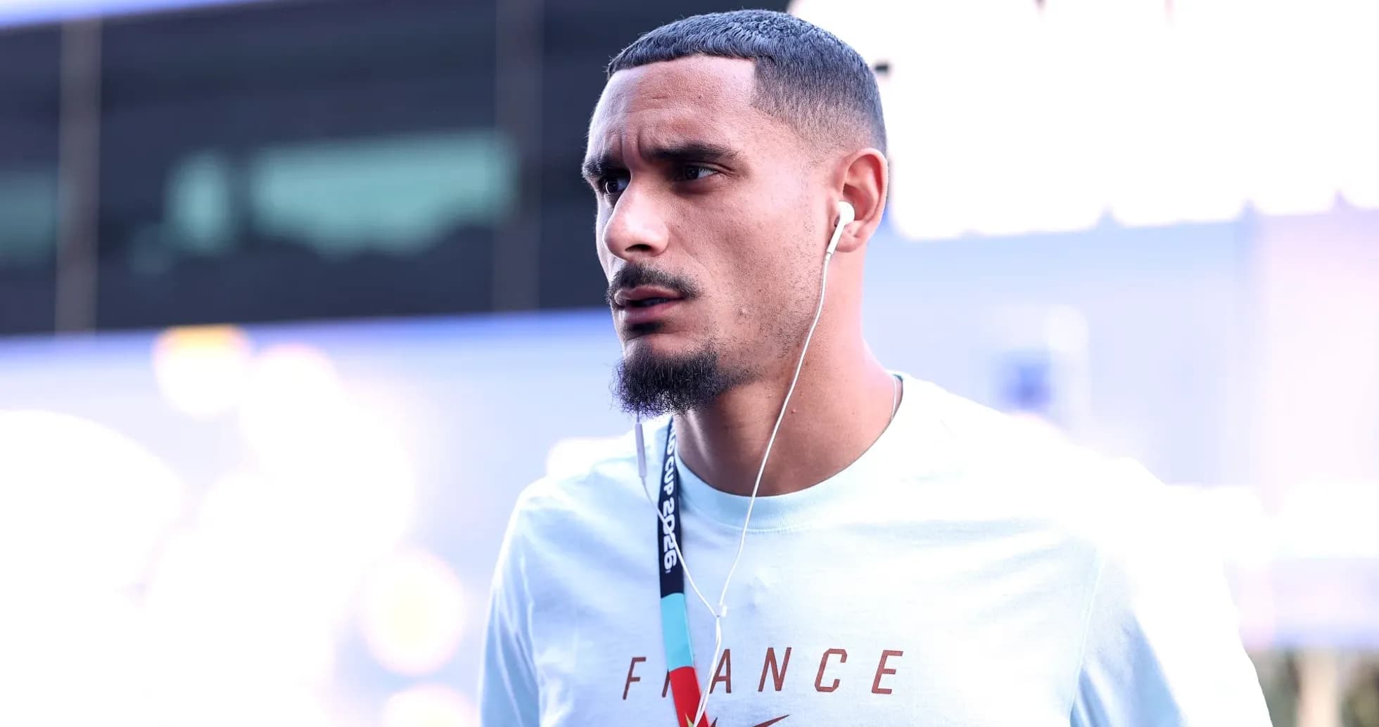 Player wearing headphones, walking towards event venue Player wearing headphones, walking towards event venue