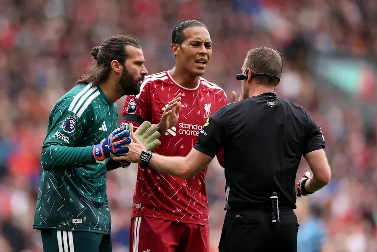 Alisson and Van Dijk discussing with referee during match Alisson and Van Dijk discussing with referee during match
