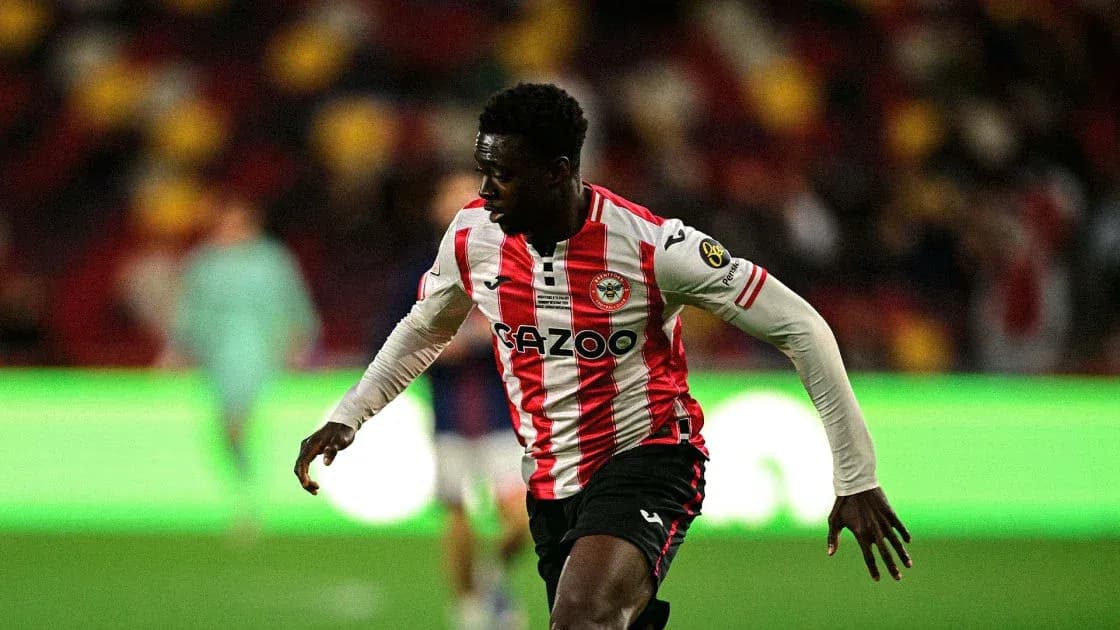 Player in Brentford kit running on the pitch Player in Brentford kit running on the pitch