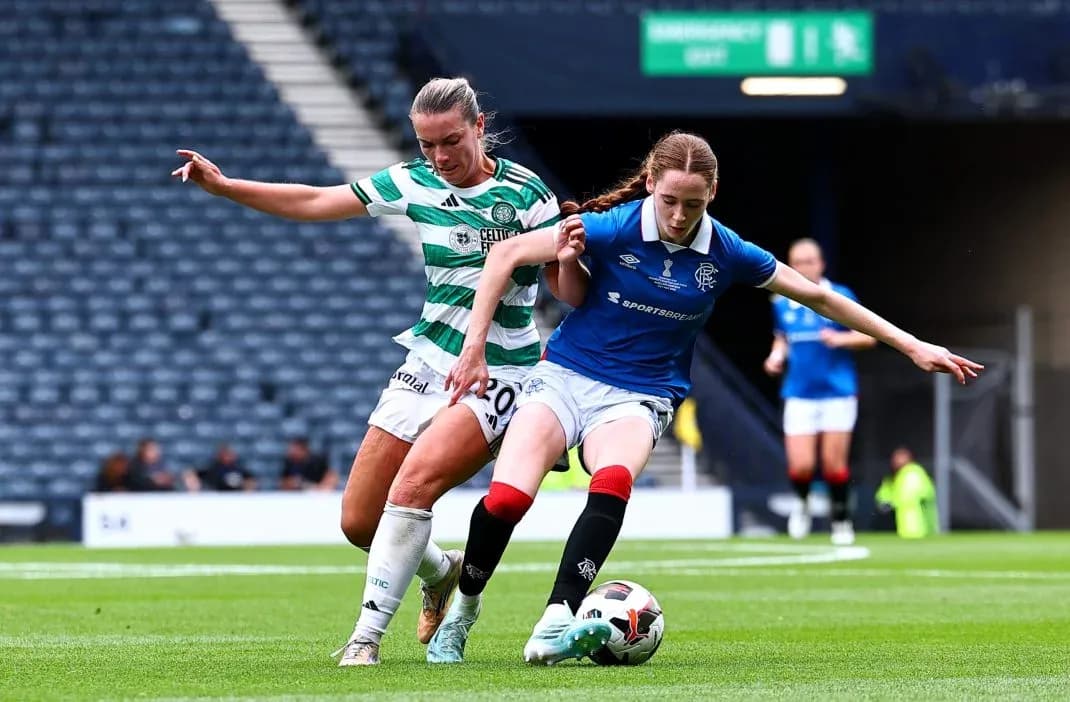 Celtic and Rangers players contesting the ball on field Celtic and Rangers players contesting the ball on field