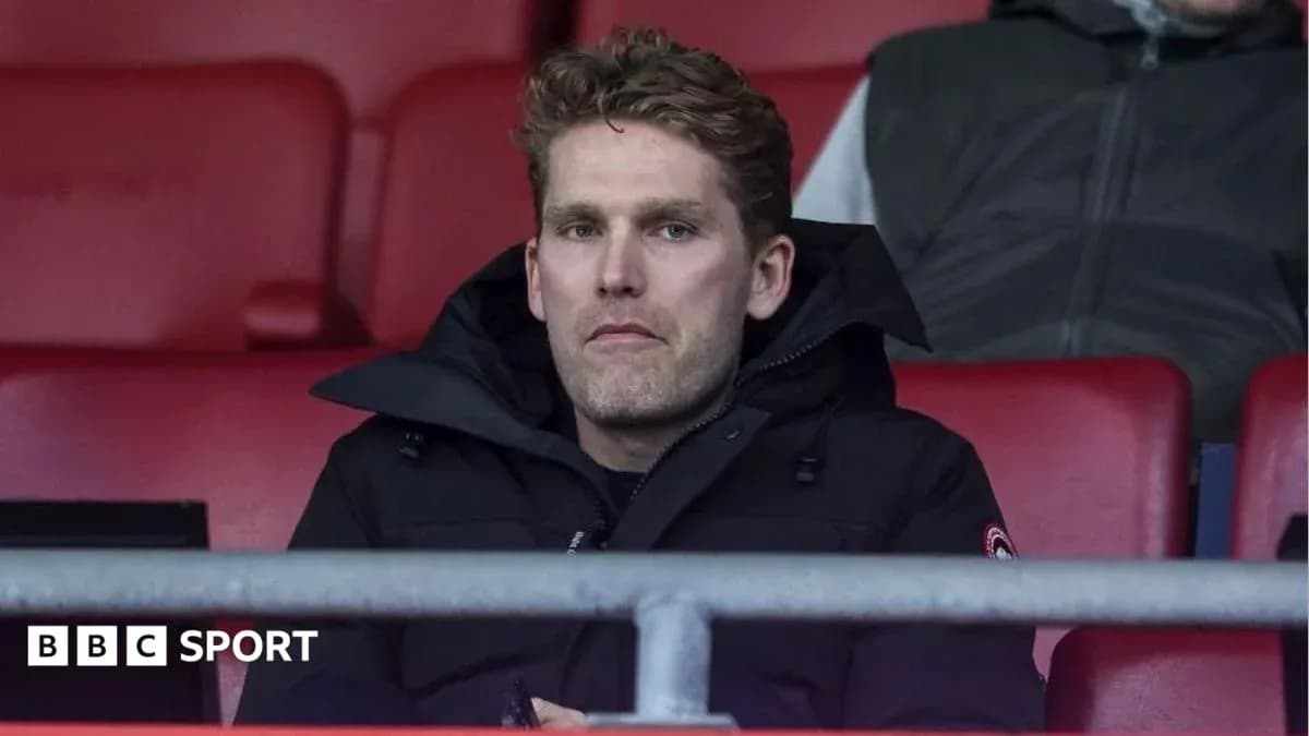 Person seated in stadium during a match Person seated in stadium during a match