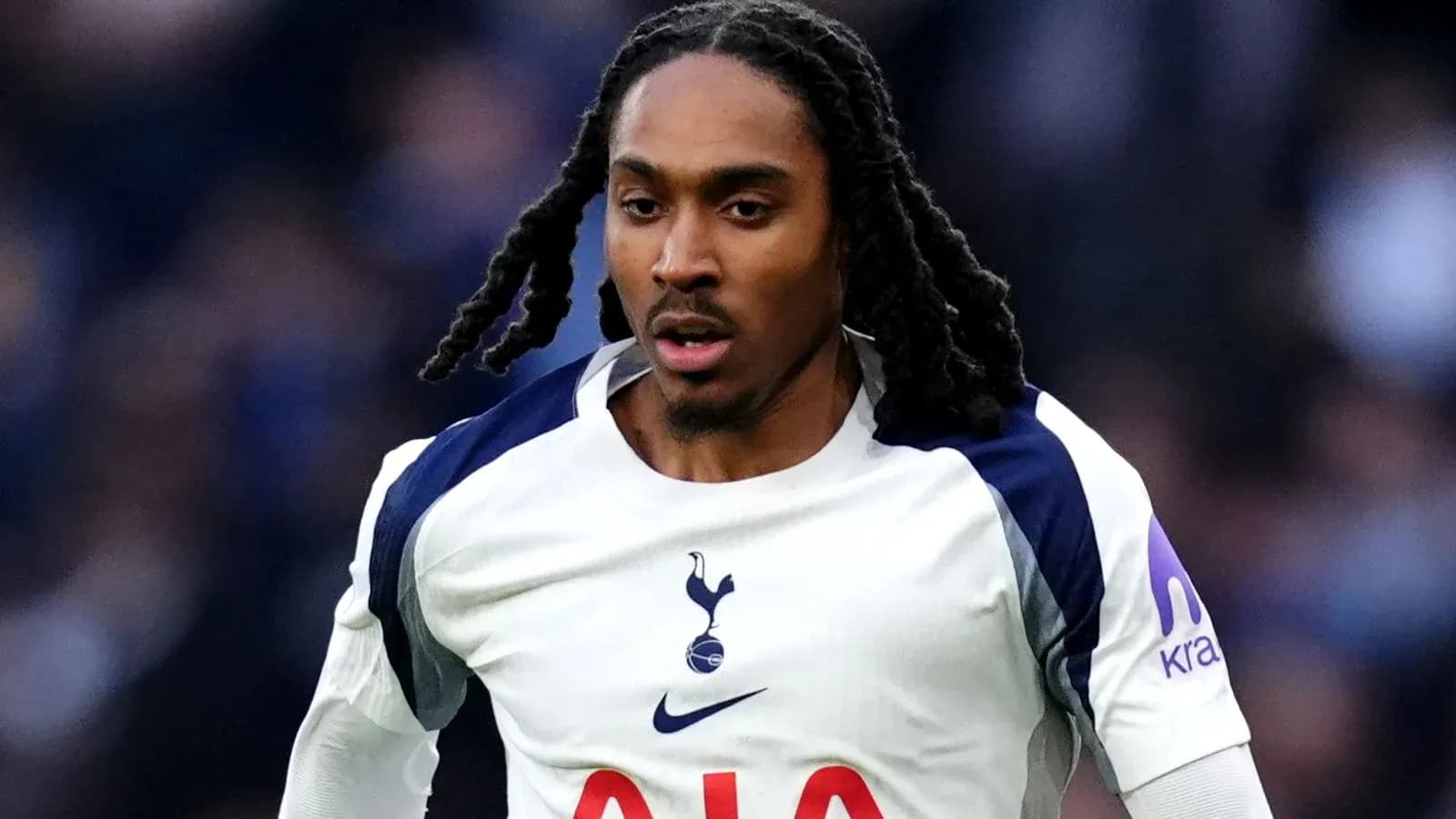Player in Tottenham kit running on the pitch Player in Tottenham kit running on the pitch
