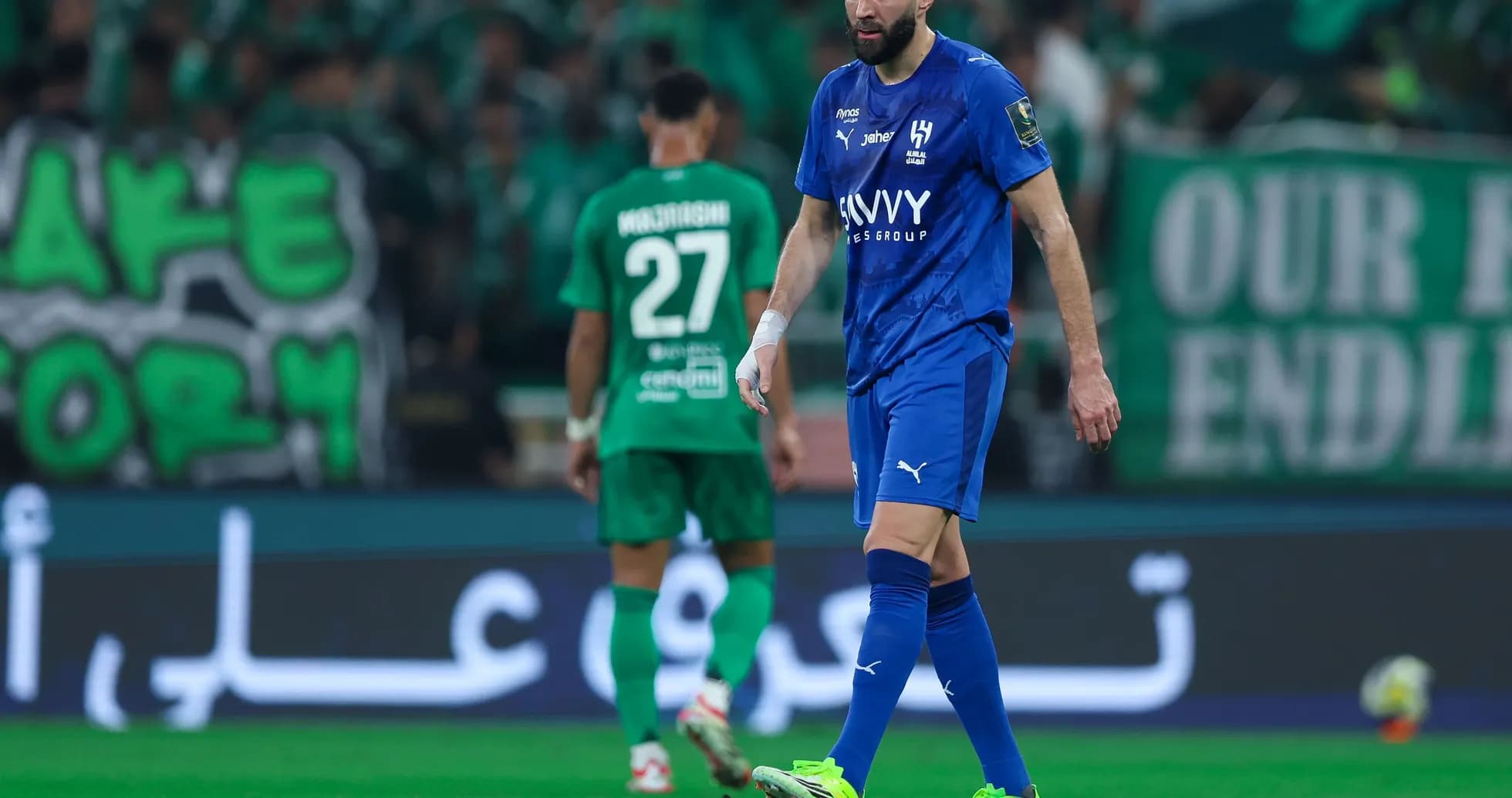 Player in blue jersey walking on the field Player in blue jersey walking on the field