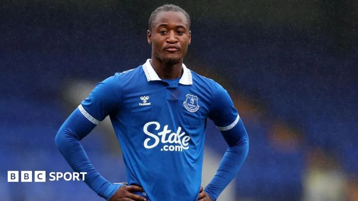 Everton player standing on the pitch in blue kit Everton player standing on the pitch in blue kit