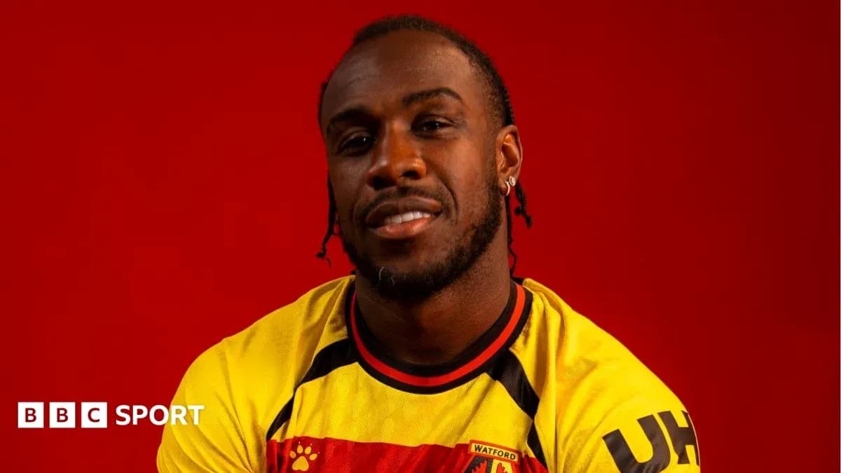 Player wearing Watford jersey against red background Player wearing Watford jersey against red background