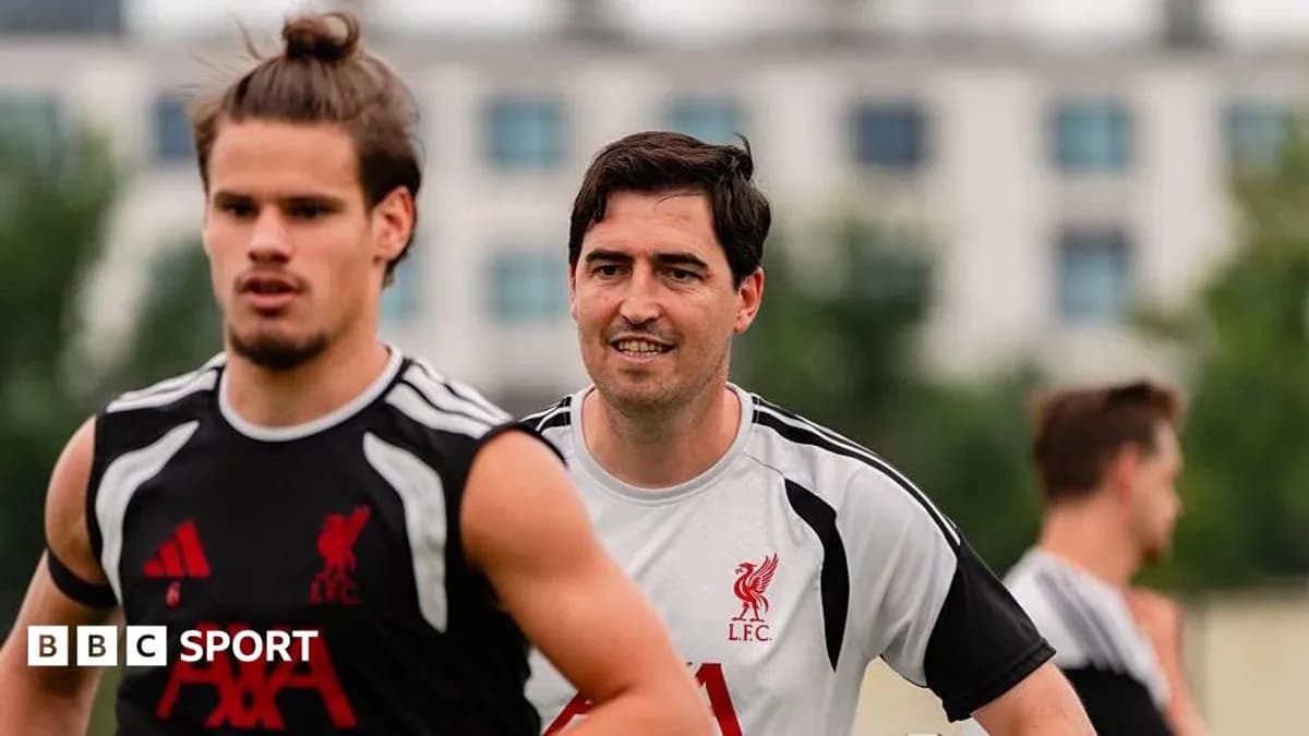 Two Liverpool players training on the pitch Two Liverpool players training on the pitch
