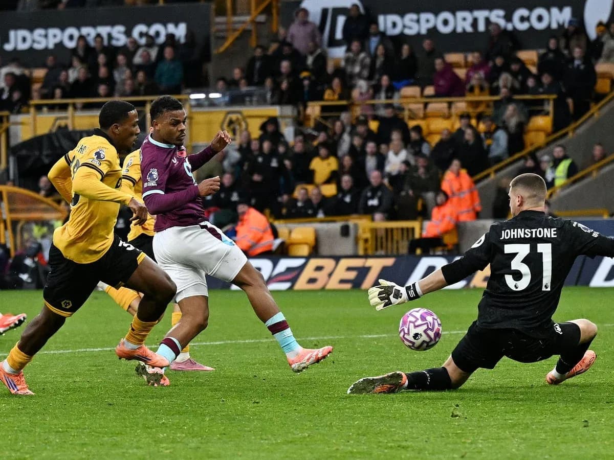 Player attempting to score against goalkeeper during match Player attempting to score against goalkeeper during match