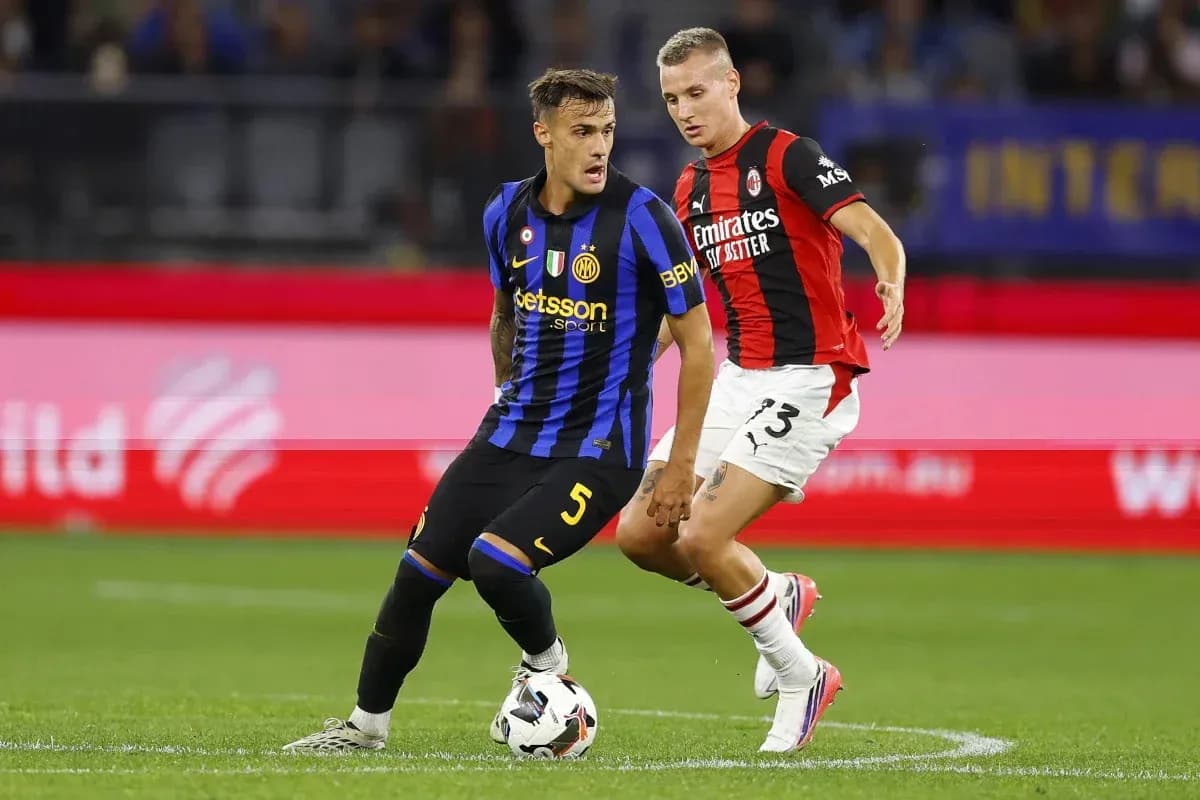 Inter Milan player dribbling past AC Milan defender Inter Milan player dribbling past AC Milan defender