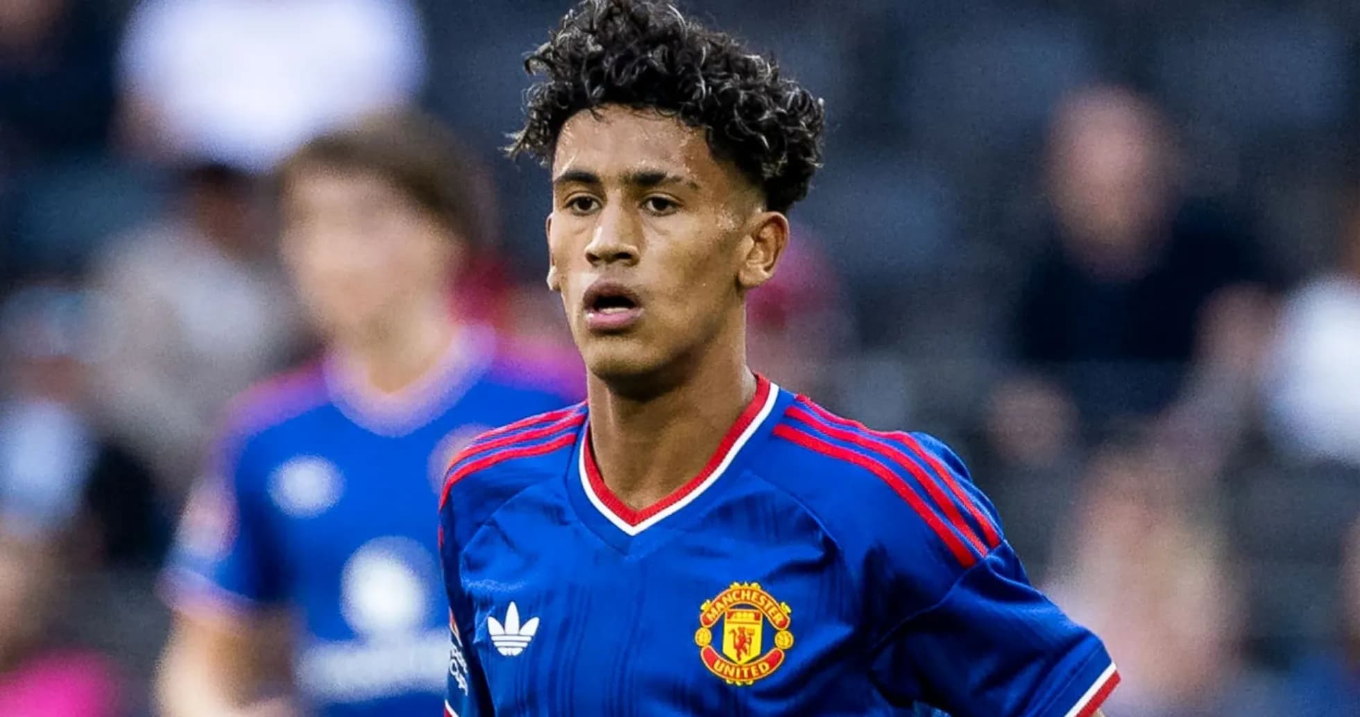 Young player in Manchester United kit on the field Young player in Manchester United kit on the field