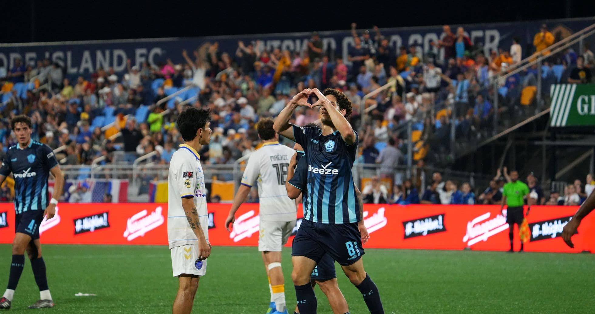 Player celebrating with fans during Rhode Island match Player celebrating with fans during Rhode Island match