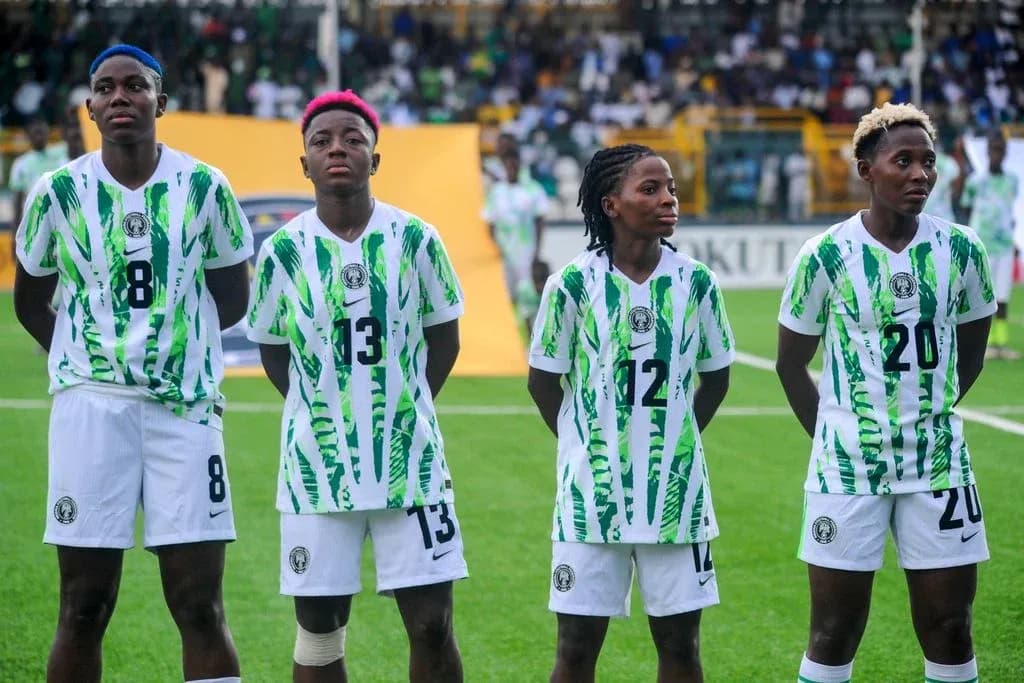Four Nigerian players in team jerseys standing together Four Nigerian players in team jerseys standing together