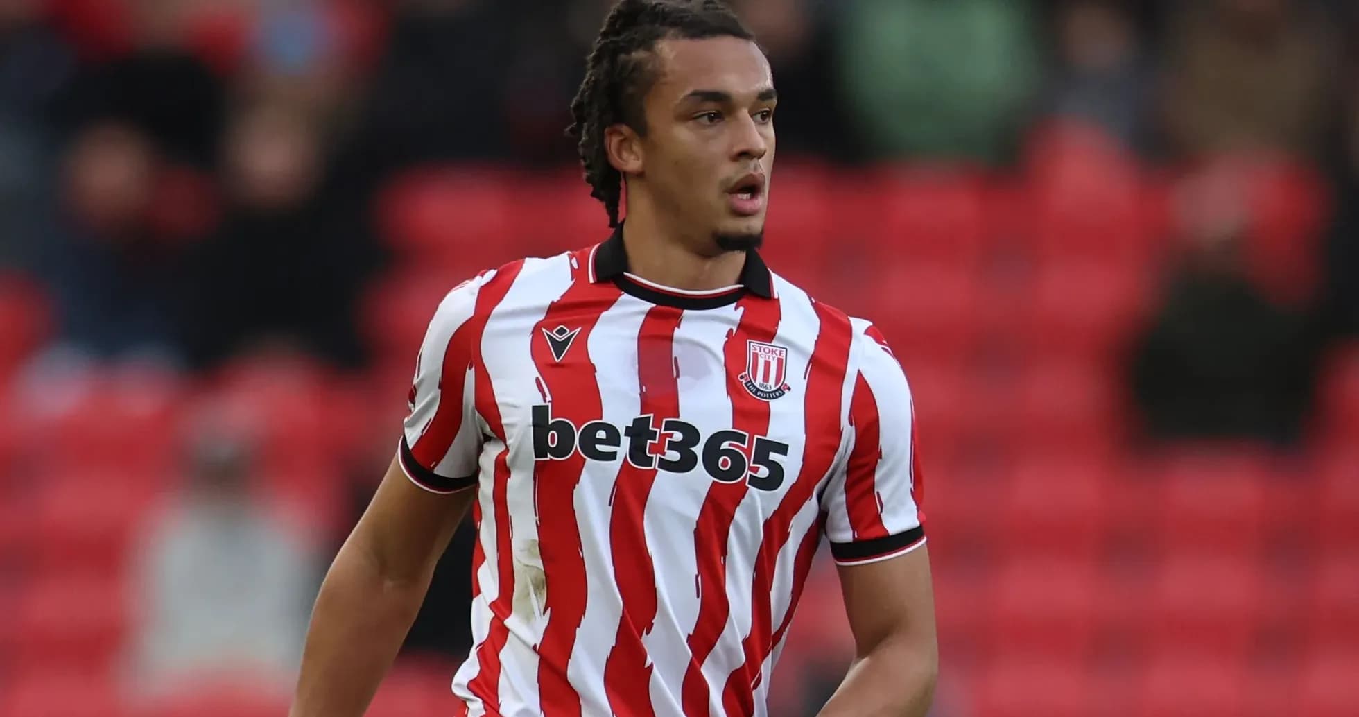Player wearing Stoke City kit on the pitch Player wearing Stoke City kit on the pitch