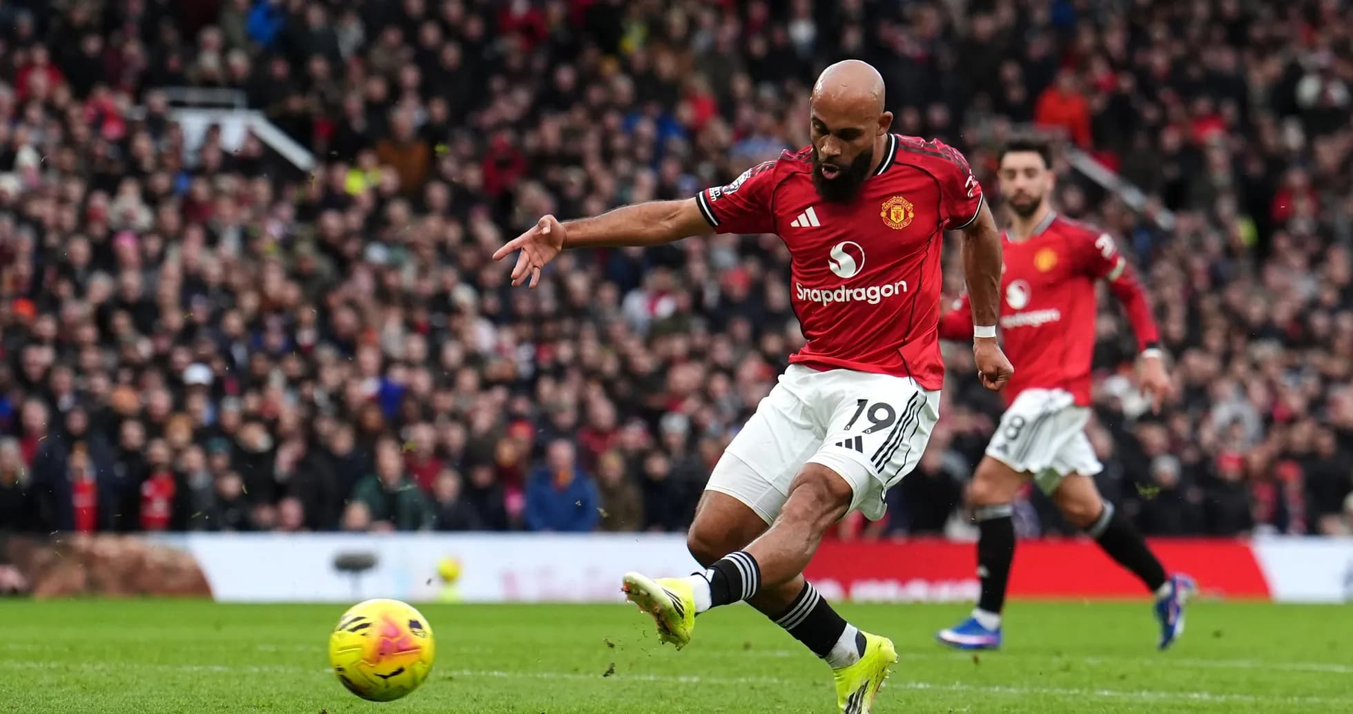 Manchester United player taking a shot on goal Manchester United player taking a shot on goal