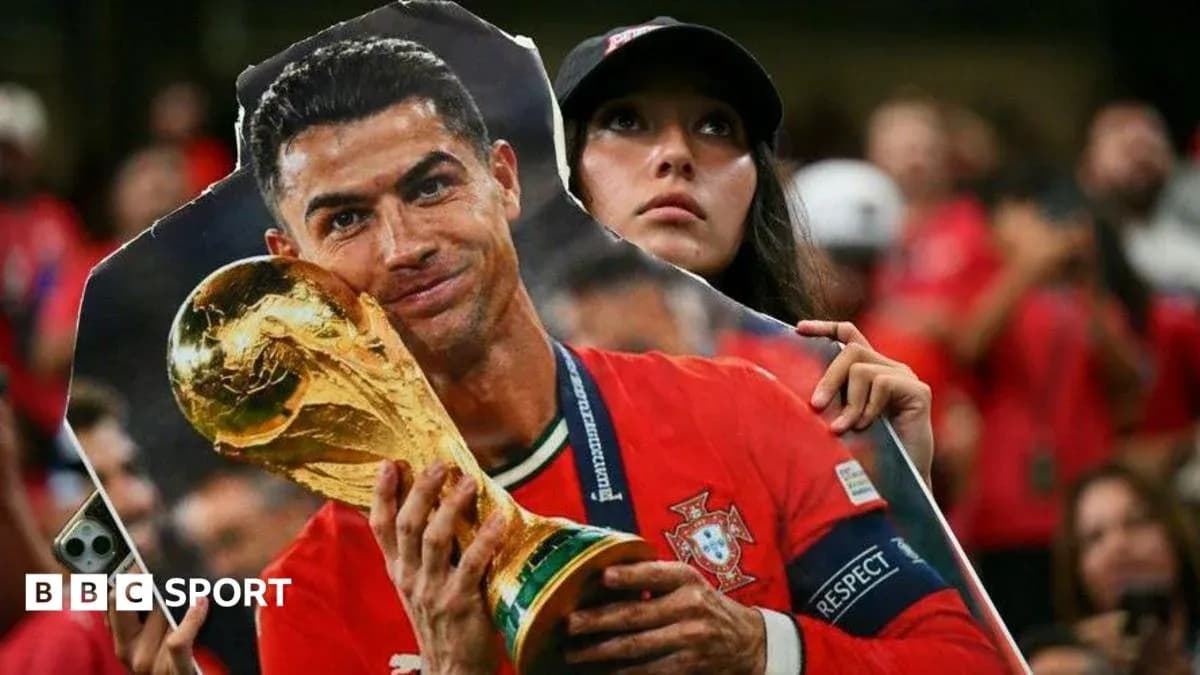 Fan holding Cristiano Ronaldo cutout with trophy Fan holding Cristiano Ronaldo cutout with trophy