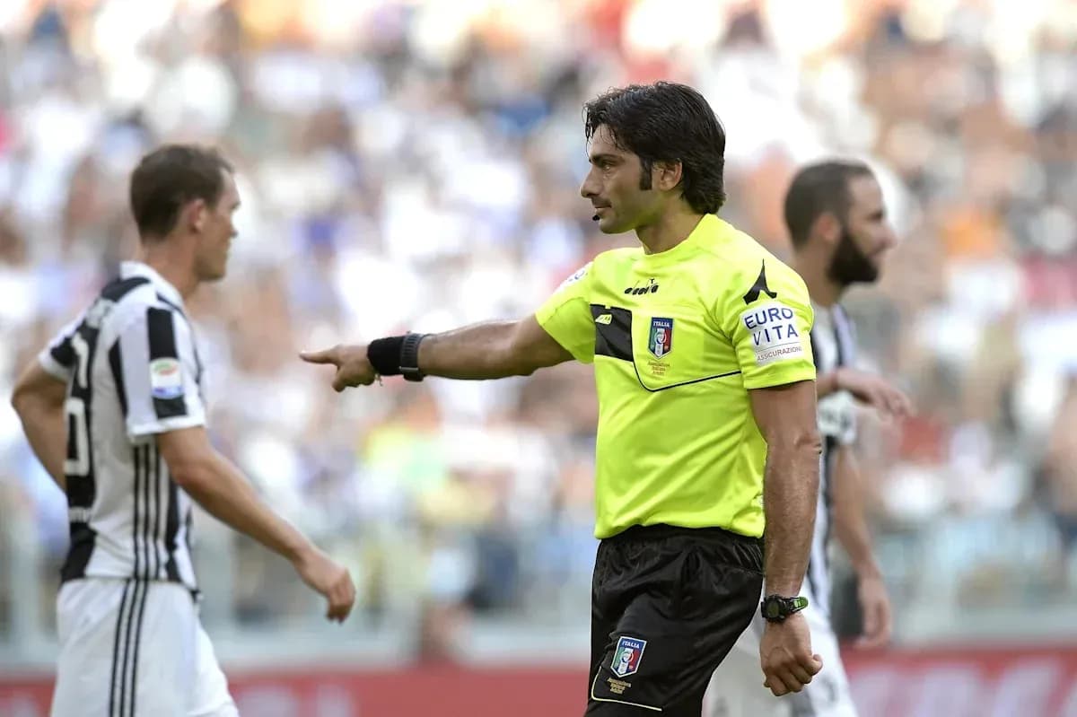 Referee signaling during Juventus match with players Referee signaling during Juventus match with players
