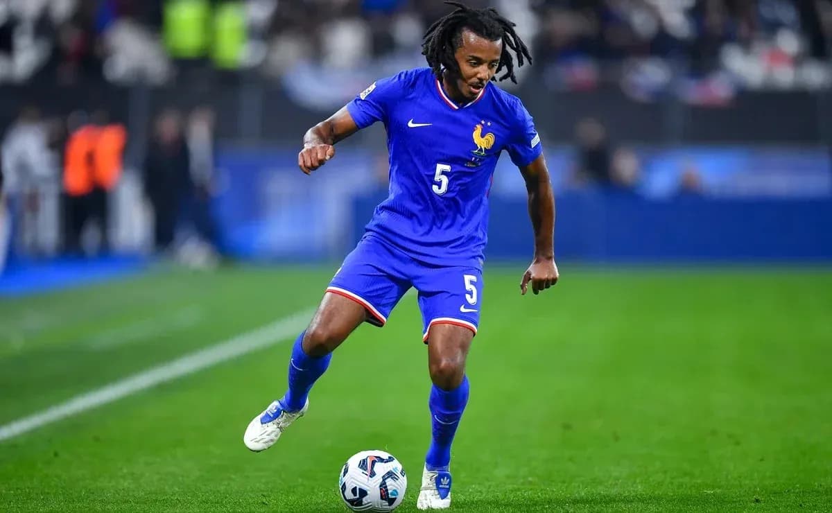Player dribbling the ball during a football match Player dribbling the ball during a football match