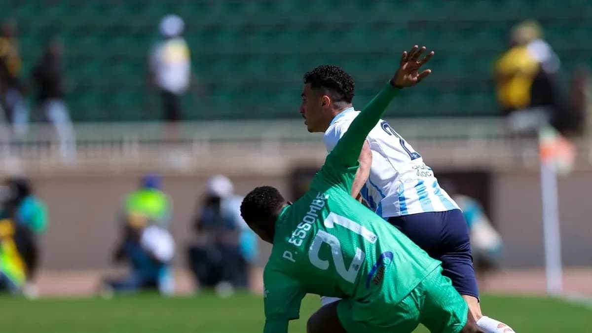 Player tackling opponent during CAF Champions League match Player tackling opponent during CAF Champions League match