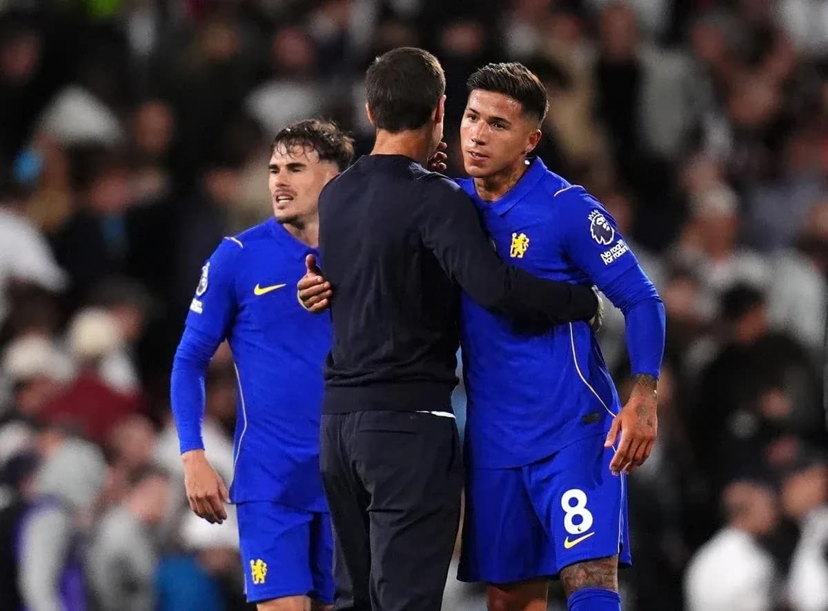 Chelsea players and manager embracing on the pitch Chelsea players and manager embracing on the pitch