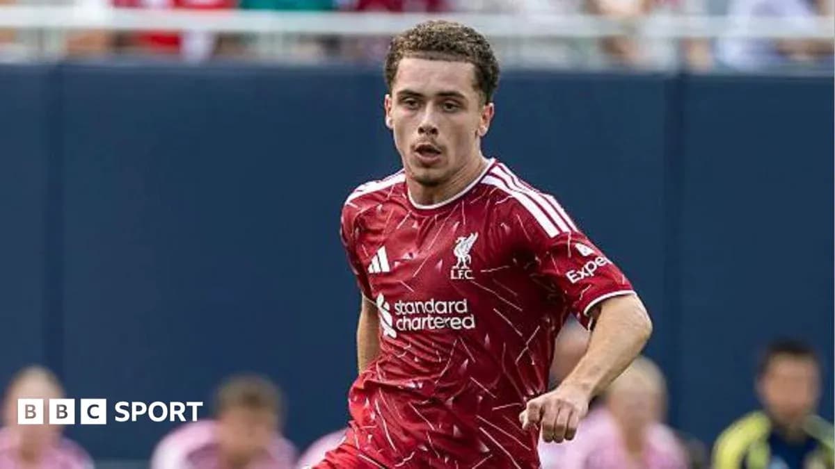 Player in Liverpool kit running on the pitch Player in Liverpool kit running on the pitch