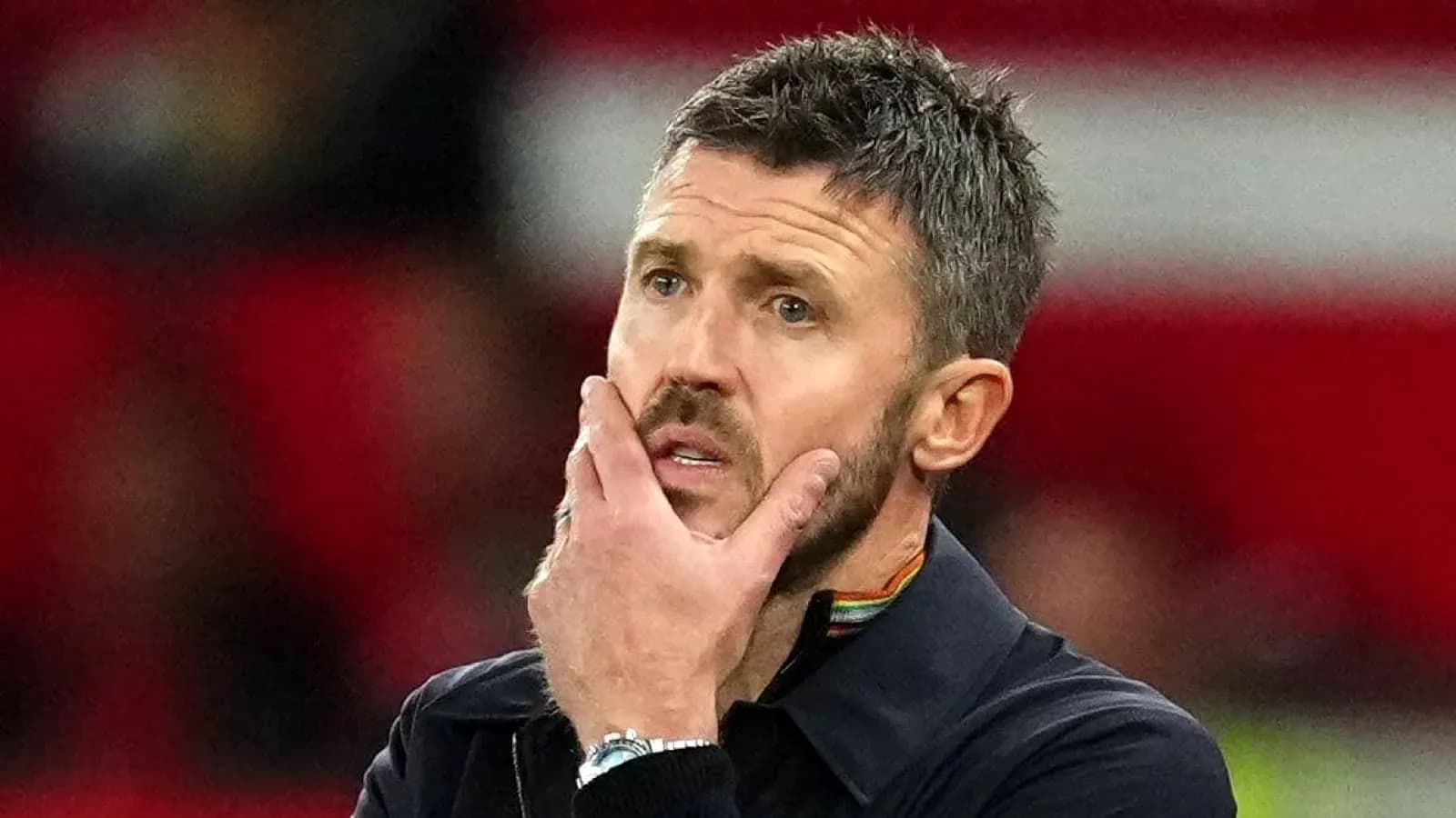 Coach with hand on chin during match Coach with hand on chin during match