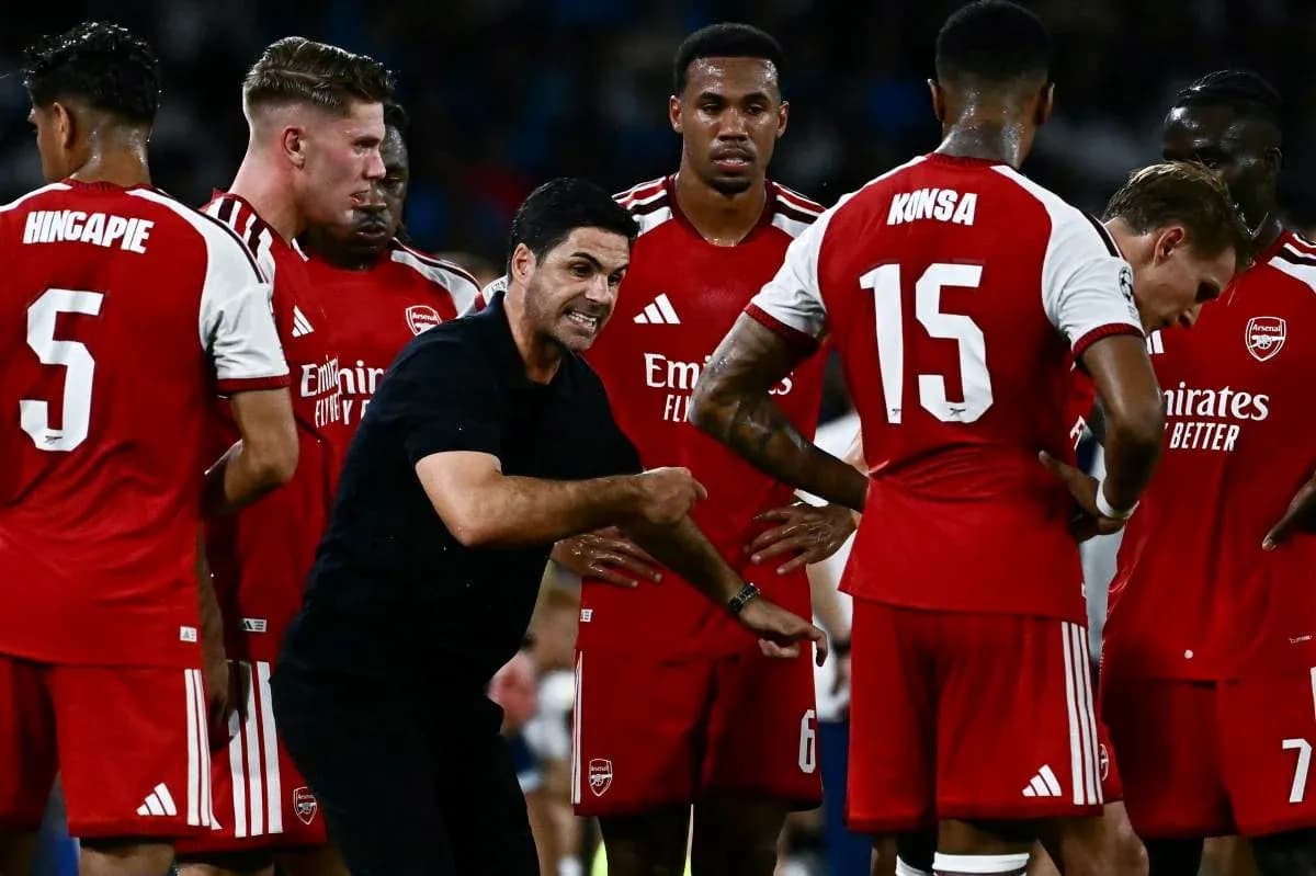 Manager instructing Arsenal players during a team huddle Manager instructing Arsenal players during a team huddle