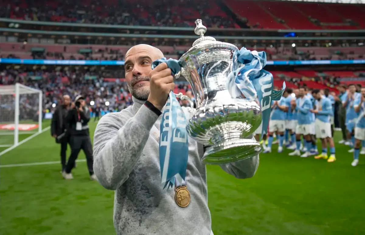 Coach holding FA Cup trophy at Wembley Stadium Coach holding FA Cup trophy at Wembley Stadium