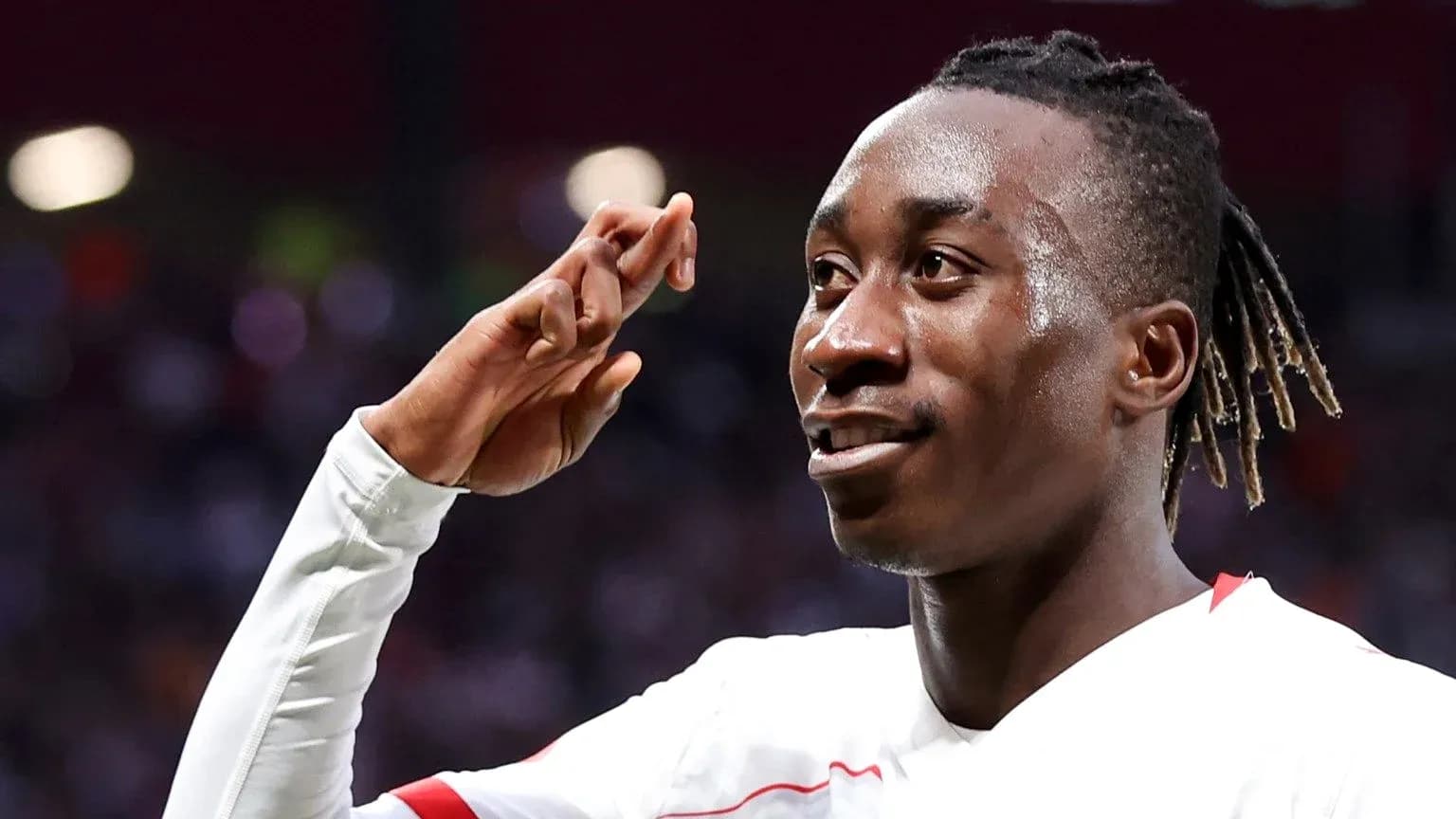 Player celebrating a goal with a salute gesture Player celebrating a goal with a salute gesture