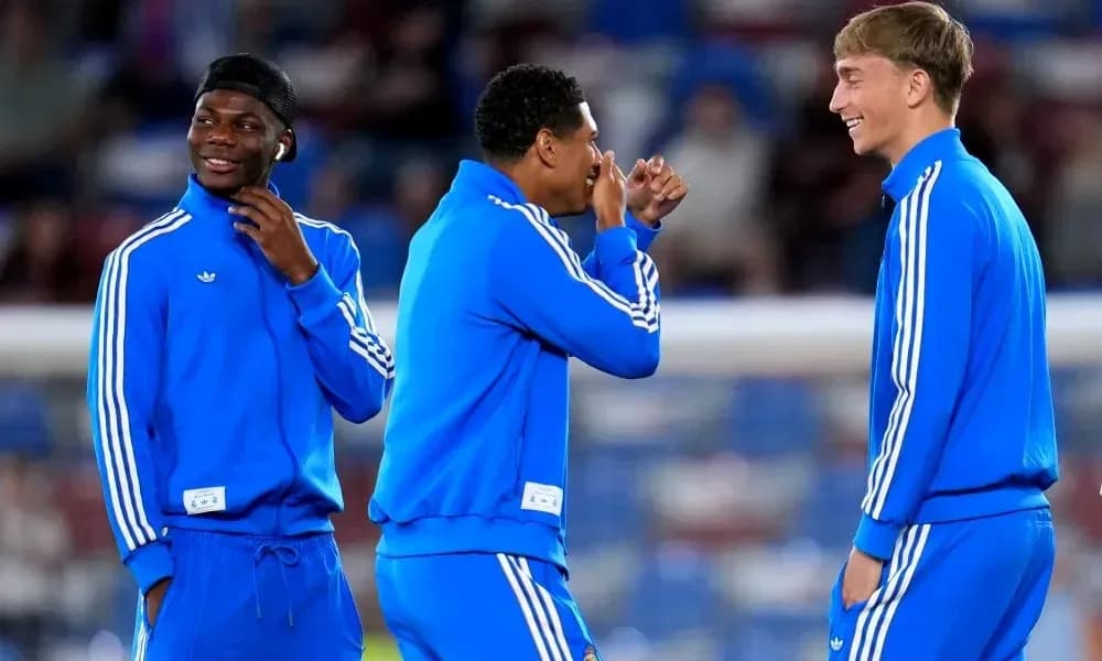 Three players chatting in blue training outfits Three players chatting in blue training outfits