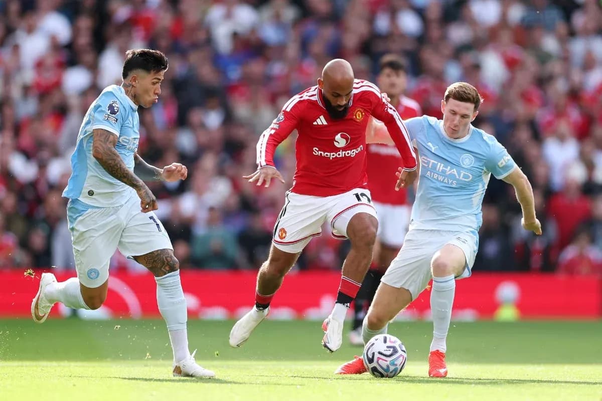 Manchester United player dribbling past Manchester City defenders Manchester United player dribbling past Manchester City defenders