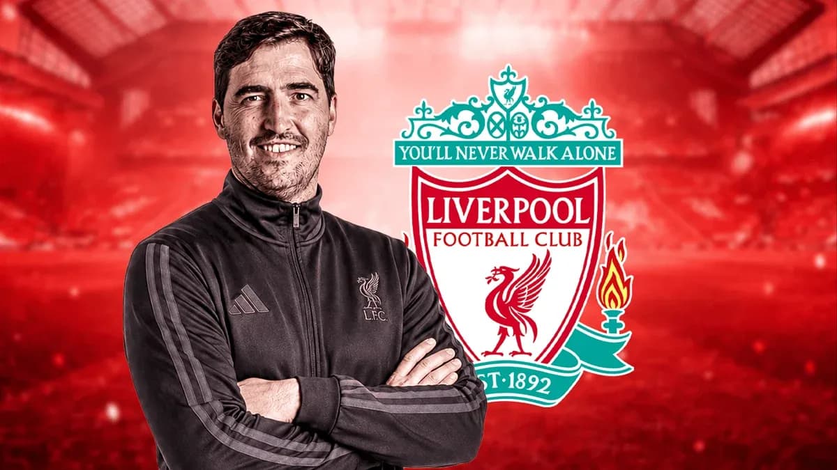 Coach posing with Liverpool FC logo in background Coach posing with Liverpool FC logo in background