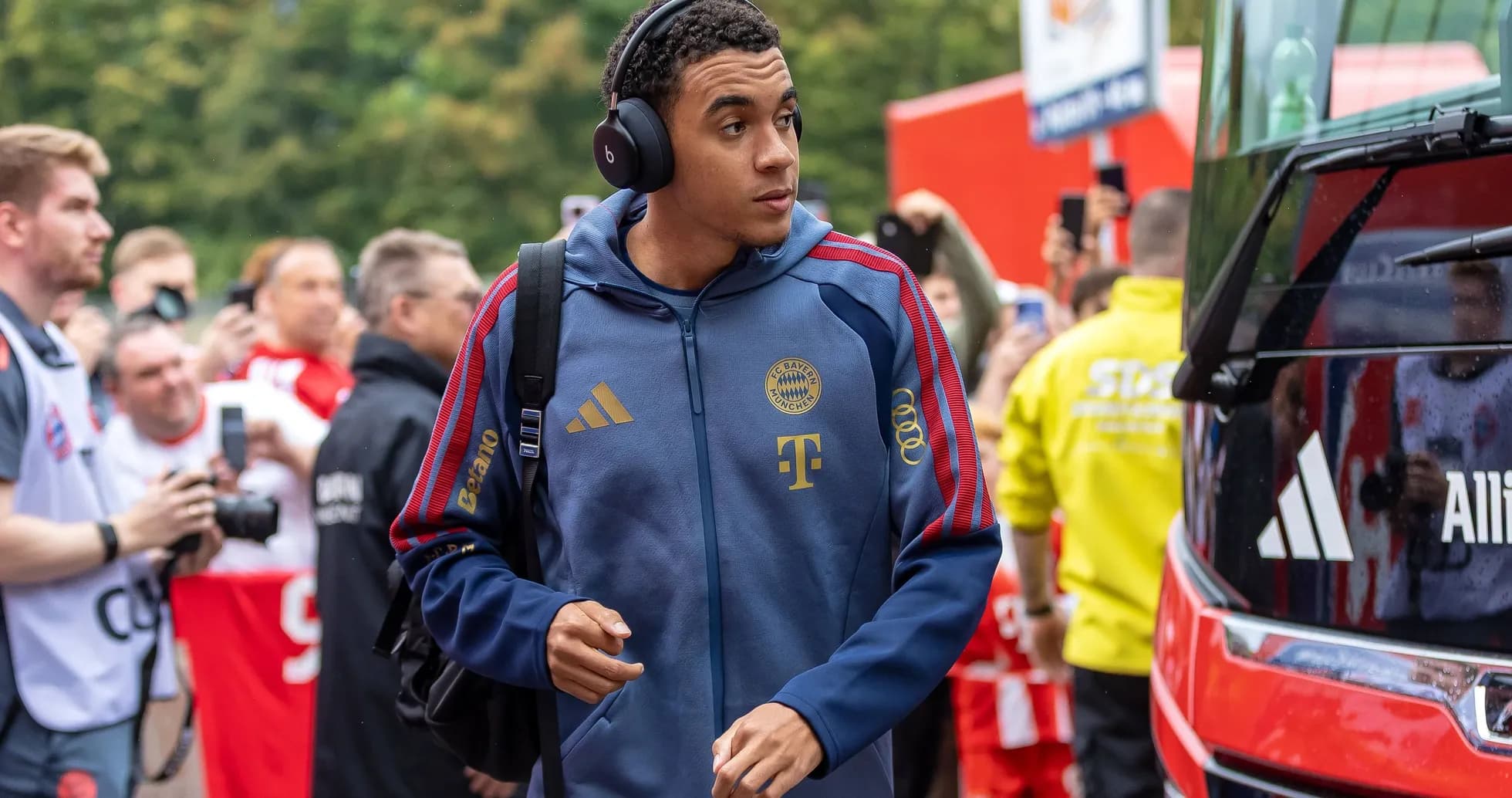 Player arriving at stadium wearing headphones and team gear Player arriving at stadium wearing headphones and team gear