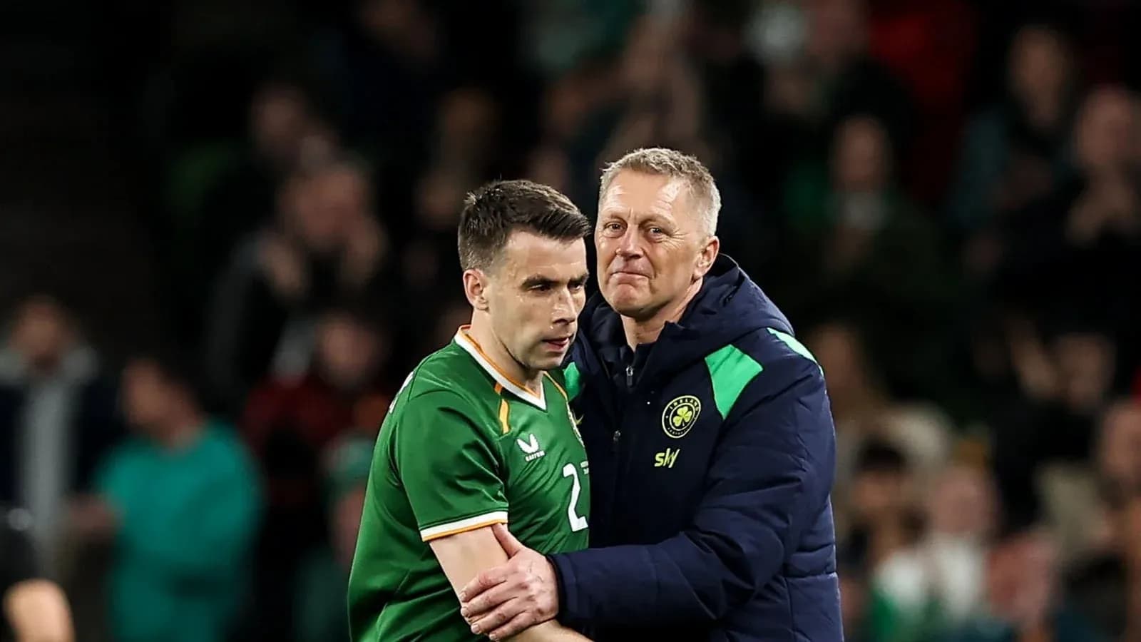 Player receiving support from coach during match Player receiving support from coach during match