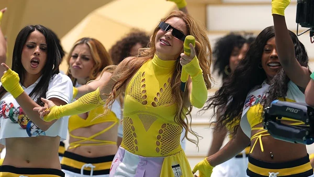 Performer singing with backup dancers in colorful outfits Performer singing with backup dancers in colorful outfits