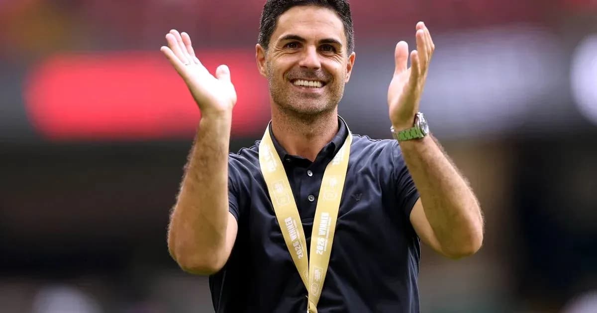 Coach celebrating with hands raised at stadium Coach celebrating with hands raised at stadium