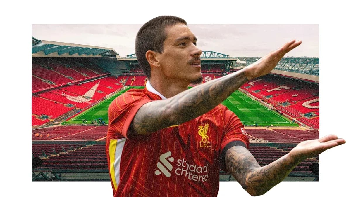 Player gesturing in front of Anfield stadium Player gesturing in front of Anfield stadium