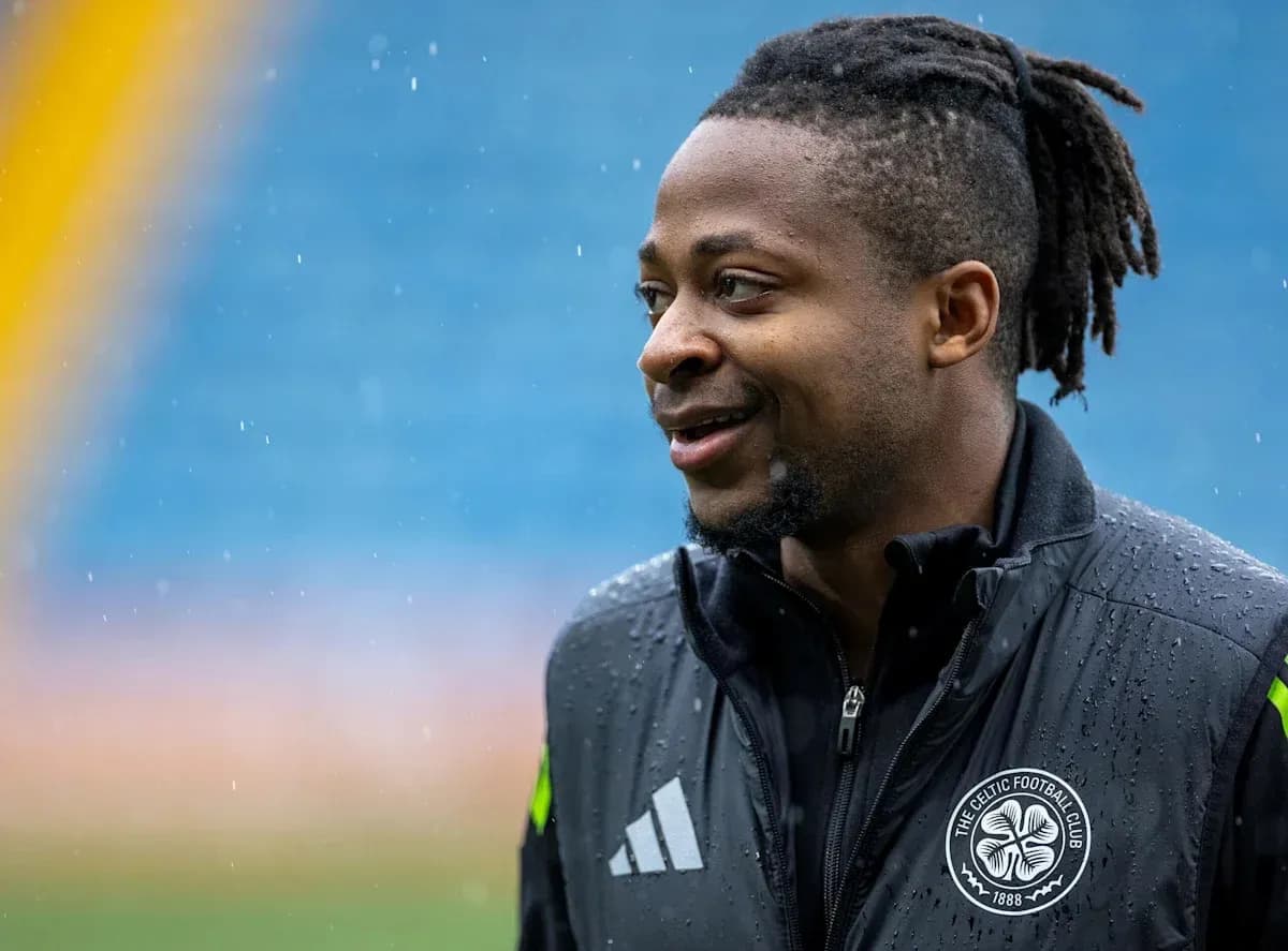 Player smiling during rainy training session Player smiling during rainy training session