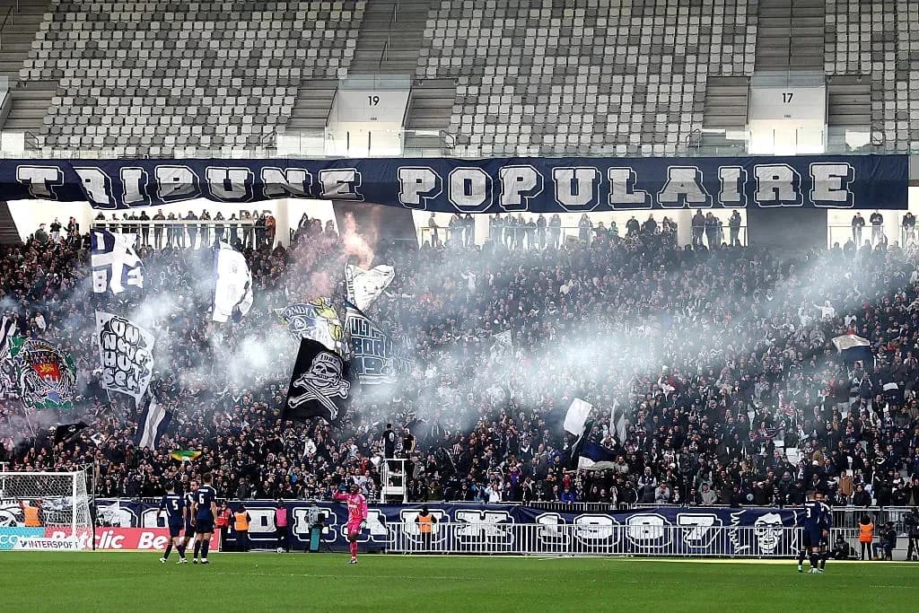 Crowd cheering with flags and smoke during match Crowd cheering with flags and smoke during match