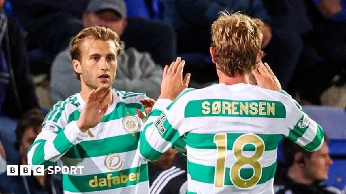 Celtic players exchanging a high five on pitch Celtic players exchanging a high five on pitch