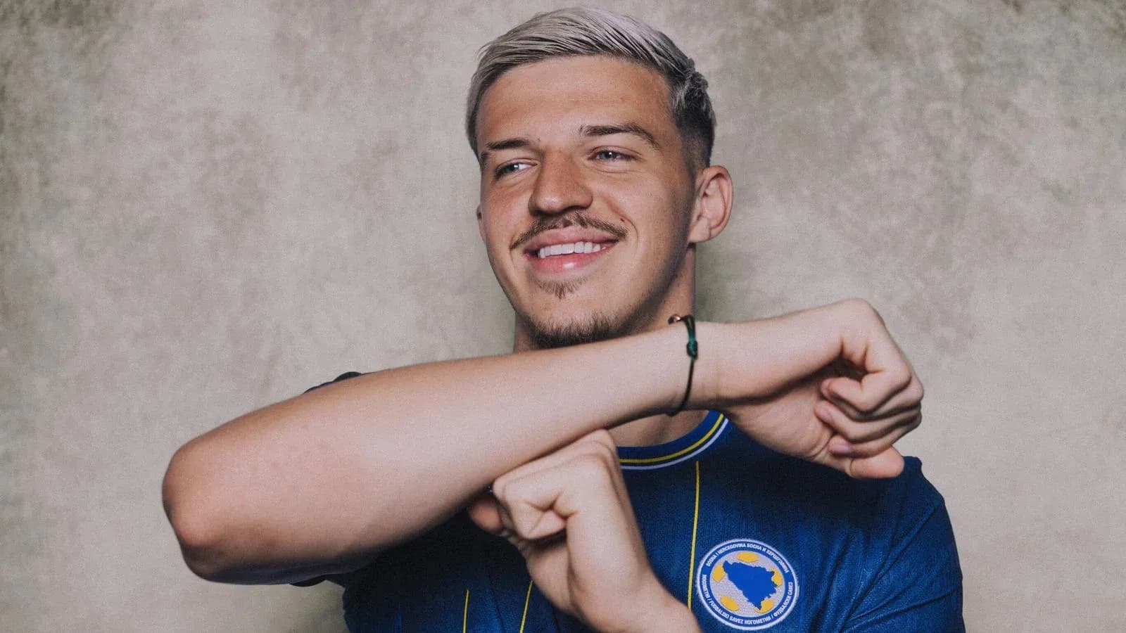 Player smiling and gesturing in team jersey Player smiling and gesturing in team jersey