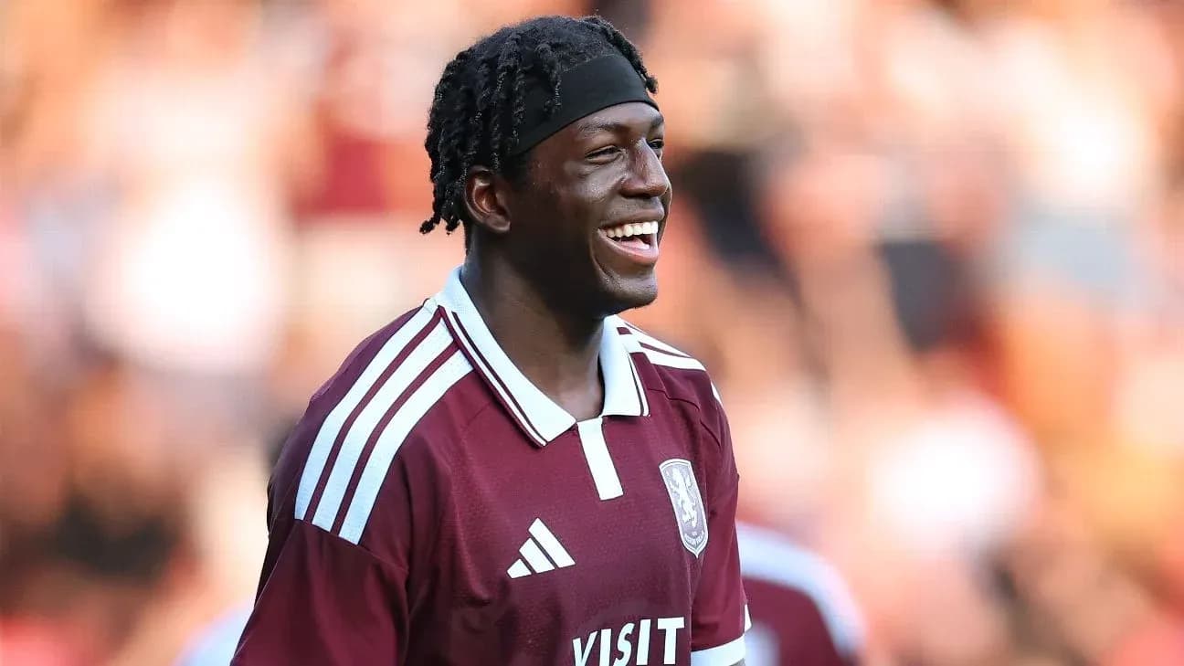 Player smiling while wearing maroon team jersey Player smiling while wearing maroon team jersey