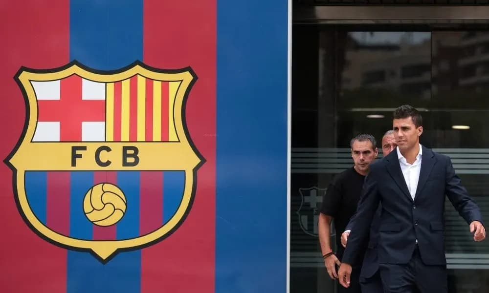 Player exiting building near FC Barcelona logo Player exiting building near FC Barcelona logo