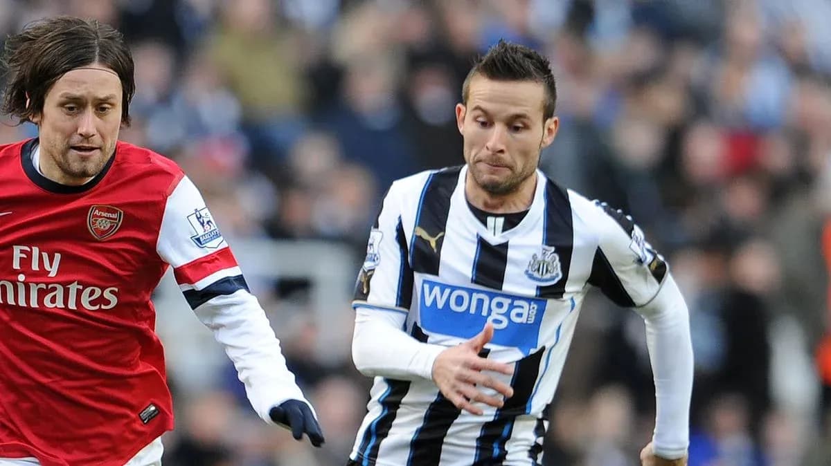 Two players running during a competitive football match Two players running during a competitive football match